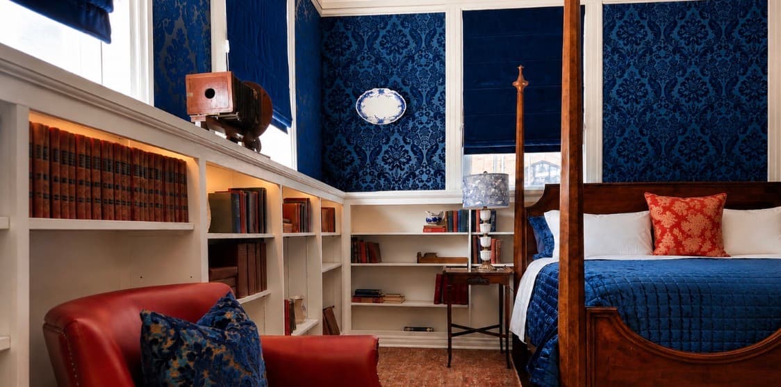 The Reading Room hero at The Library Historic Hotel — restored king suite with historic bookcases